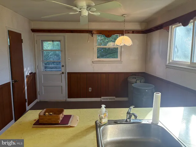 a kitchen with stainless steel appliances granite countertop a sink a refrigerator and a stove