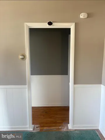 a view of hallway with wooden floor