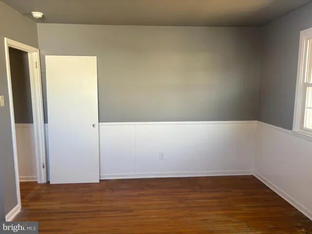 a view of hallway with wooden floor