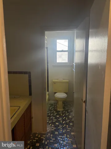 a bath tub sitting next to a white sink and a shower