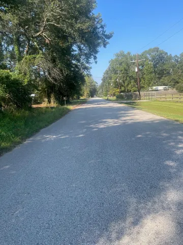 a view of a field with trees in the background
