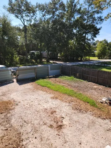 a view of swimming pool with seating area and trees around