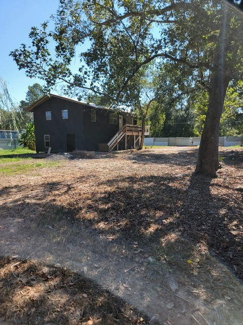 26643 Carol Lane Splendora, TX 77372 - Photo 6 of 14 a backyard of a house with large trees and a yard