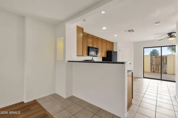 a view of a kitchen with an empty space and a window