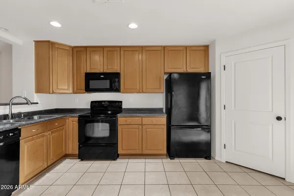 a kitchen with a refrigerator and a sink