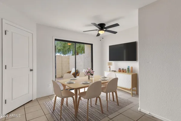 a view of a dining room with furniture and a flat screen tv