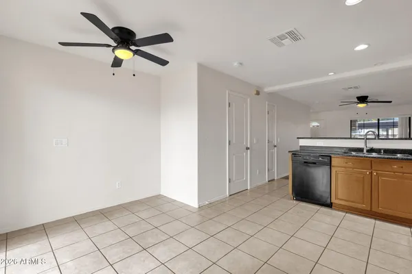 a kitchen with a refrigerator a sink dishwasher with a dining table and chairs