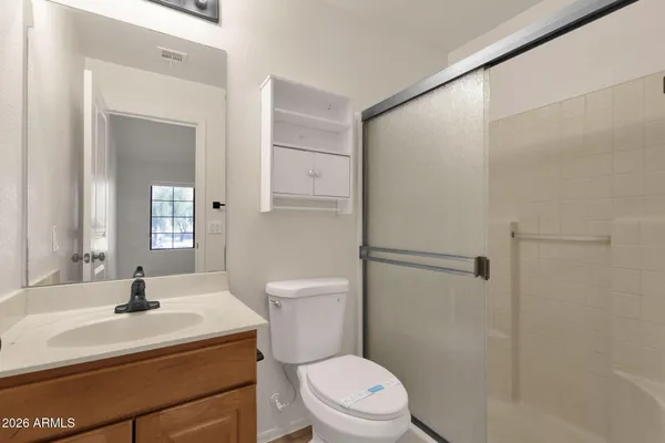 a bathroom with a sink toilet vanity and shower