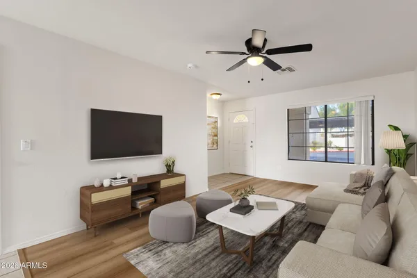 a living room with furniture and a flat screen tv