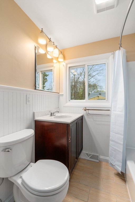 18 Royce Road Framingham, MA 01701 - Photo 14 of 30 a bathroom with a toilet sink vanity and mirror