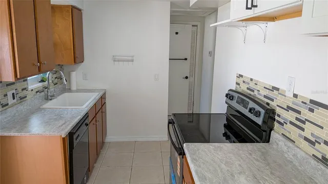a kitchen with a sink stove and cabinets