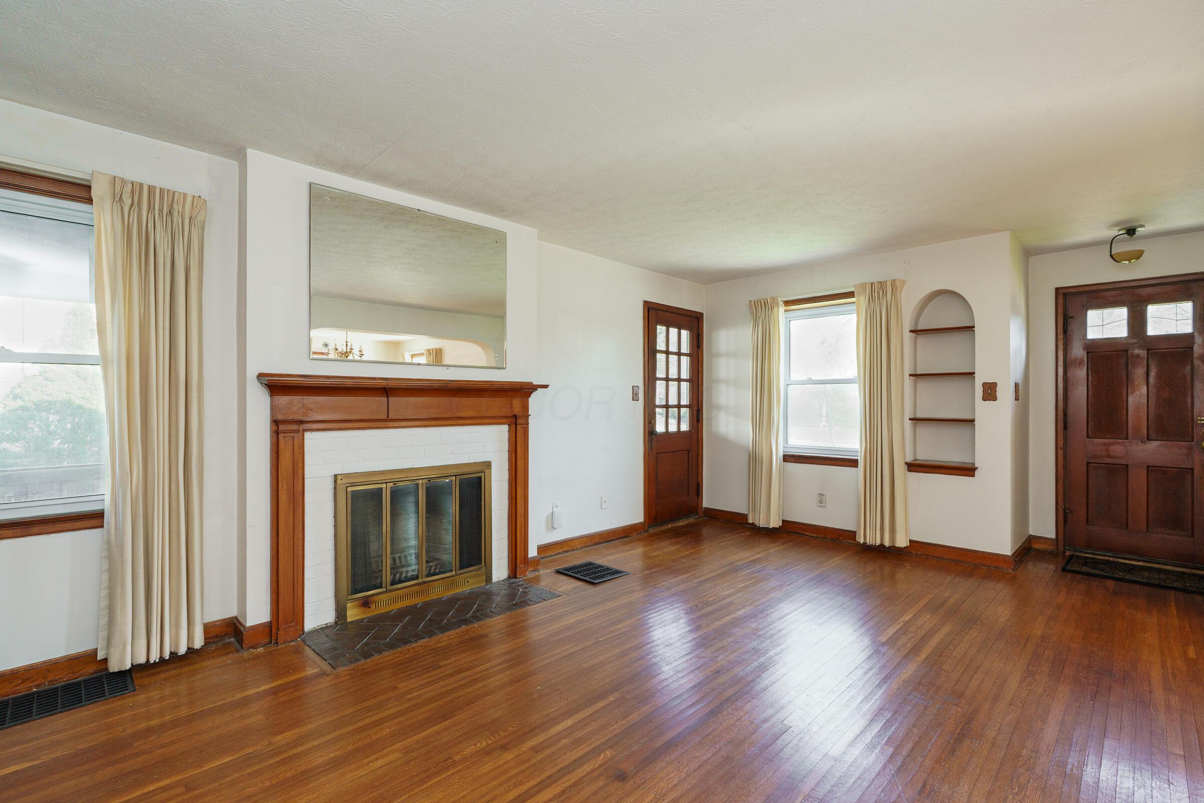 136 Fallis Road Columbus, OH 43214 - Photo 6 of 40 Built-ins, decorative fireplace and mantel and wood floors welcome you inside this classic home.