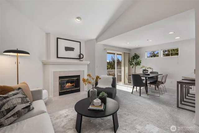 a living room with furniture a fireplace and a table