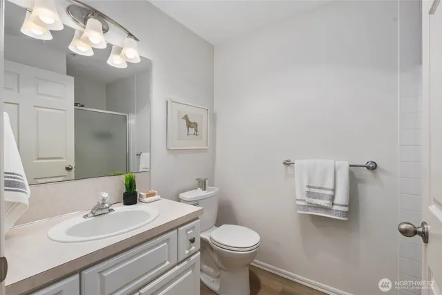 a bathroom with a sink toilet and a mirror