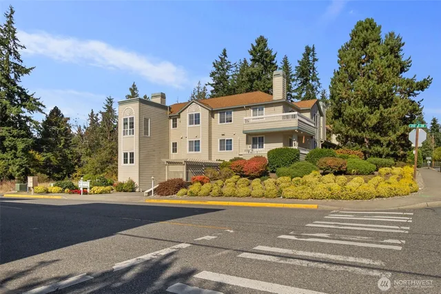 an aerial view of a house with a yard and lake view