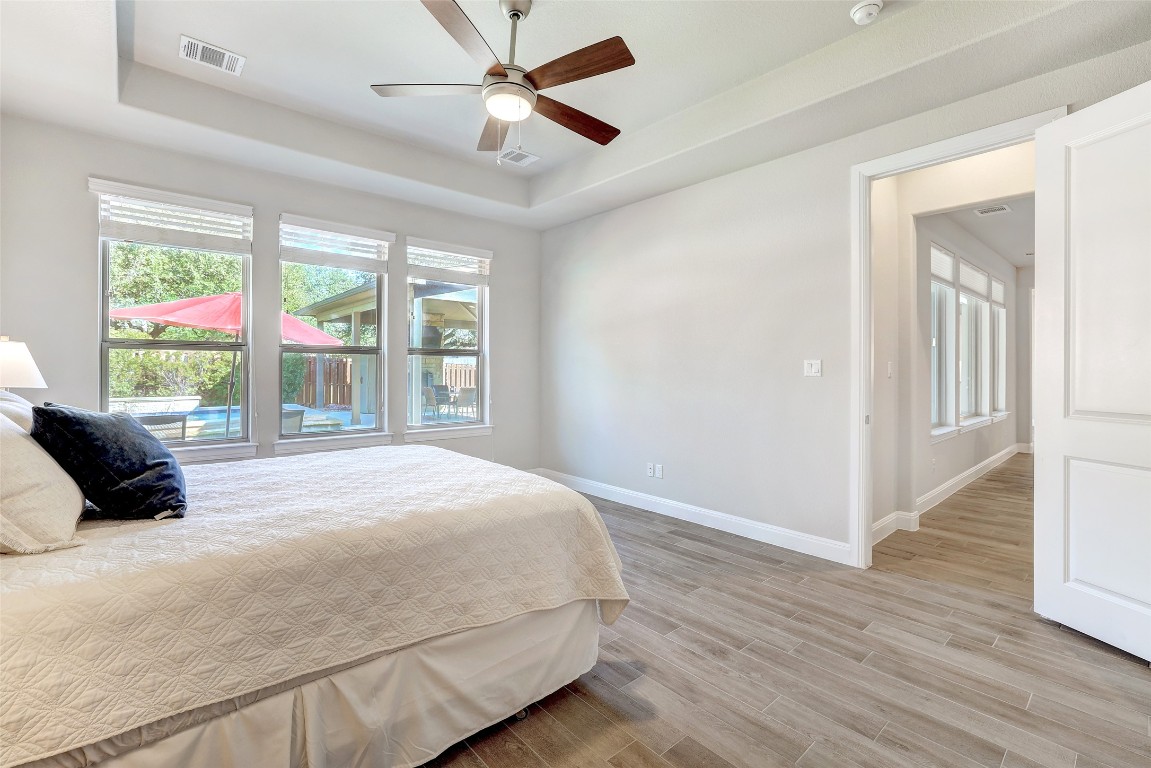 257 Axis Loop Georgetown, TX 78628 - Photo 14 of 40 a bedroom with a large bed and a large window