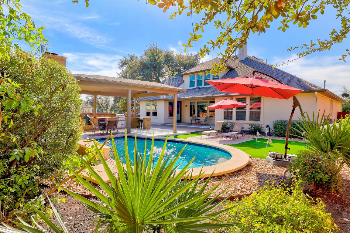257 Axis Loop Georgetown, TX 78628 - Photo 2 of 40 a view of a swimming pool with a patio and a yard