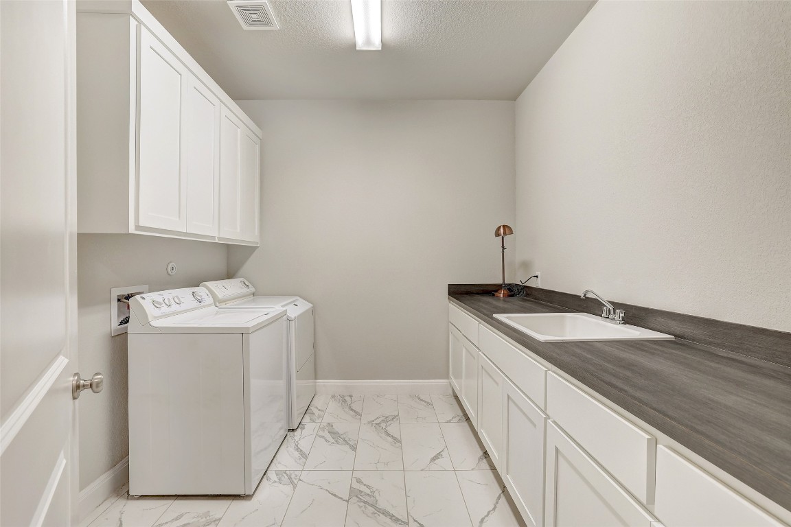 257 Axis Loop Georgetown, TX 78628 - Photo 29 of 40 a utility room with a sink washer and dryer