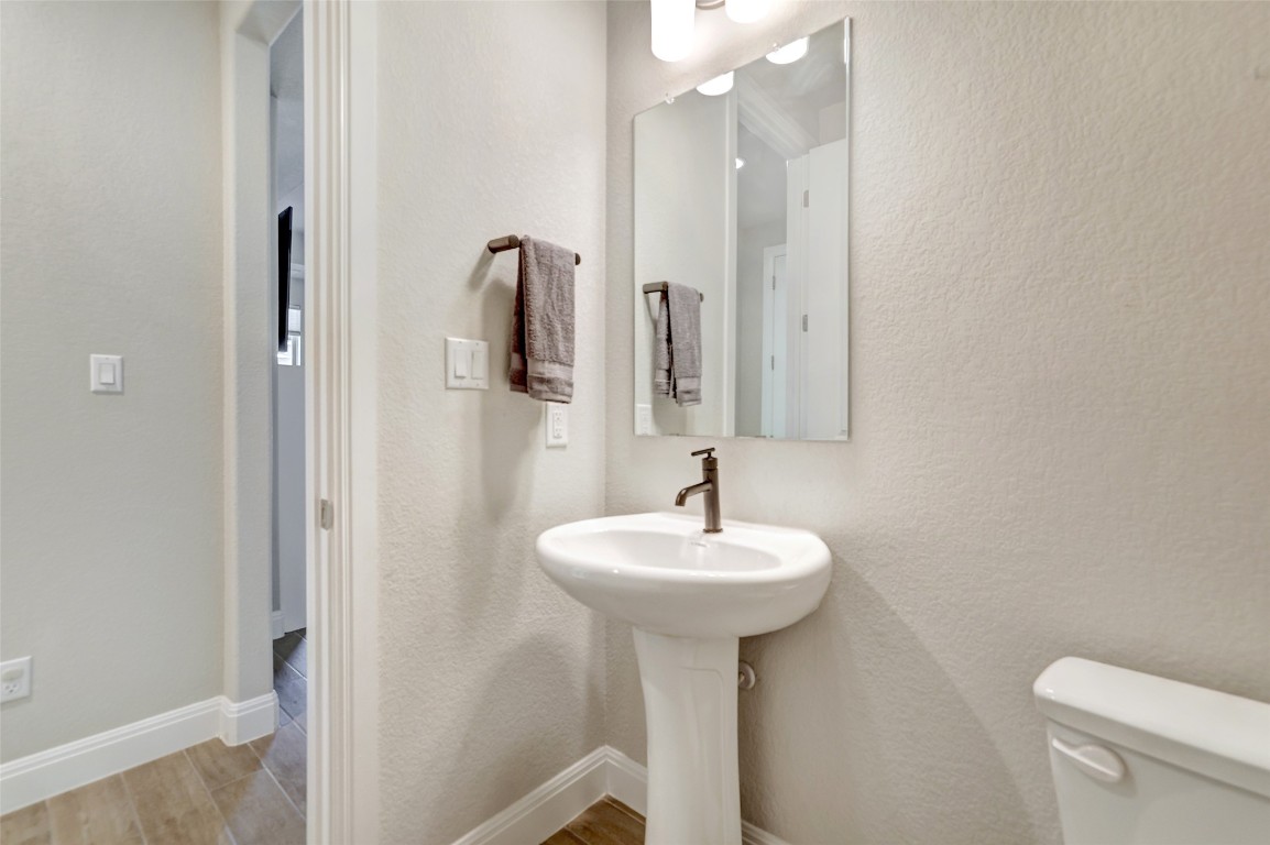 257 Axis Loop Georgetown, TX 78628 - Photo 30 of 40 a bathroom with a sink a toilet and mirror