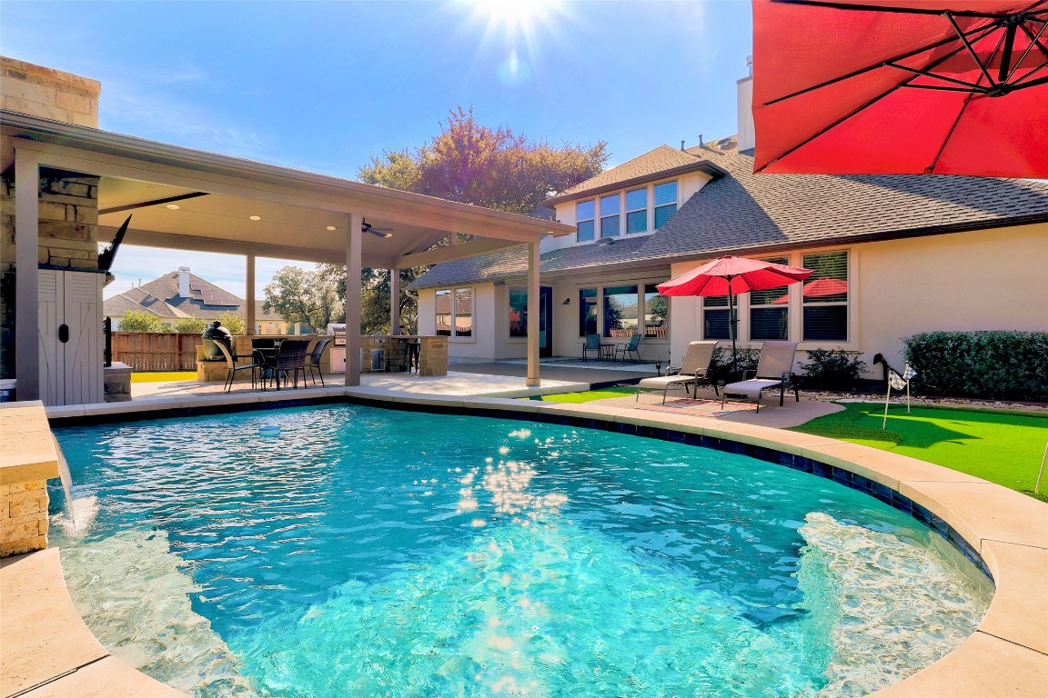 257 Axis Loop Georgetown, TX 78628 - Photo 36 of 40 a swimming pool view with a seating space and a garden view