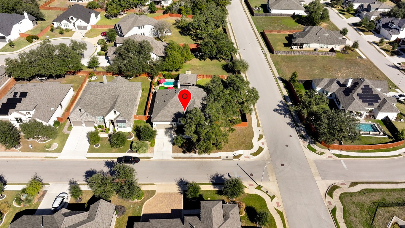 257 Axis Loop Georgetown, TX 78628 - Photo 39 of 40 an aerial view of a house with swimming pool and large trees