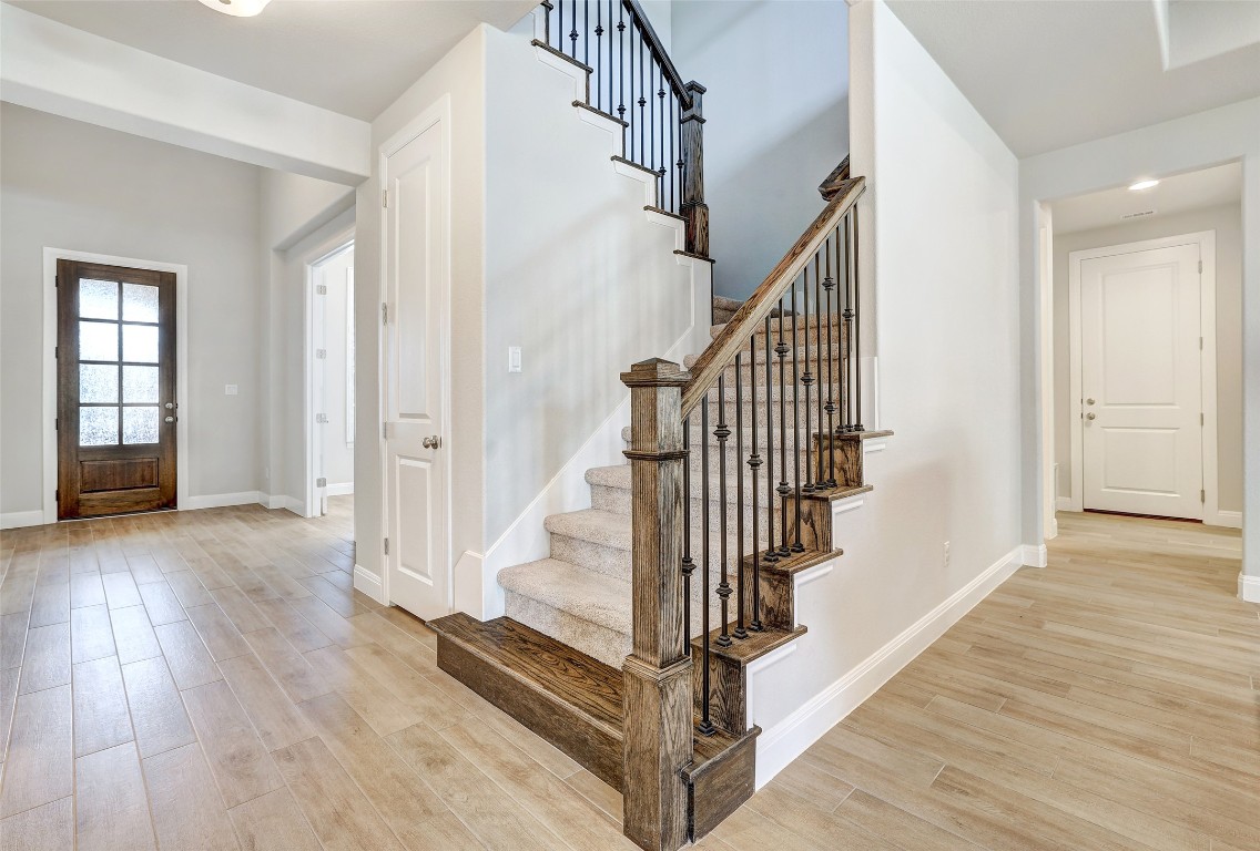 257 Axis Loop Georgetown, TX 78628 - Photo 5 of 40 a view of entryway with wooden floor and stairs