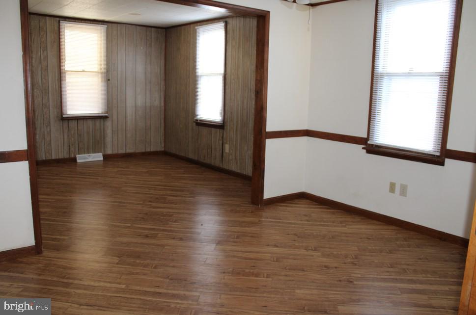 2456 Seven Valleys Road, Unit 1 Seven Valleys, PA 17360 - Photo 3 of 7 an empty room with wooden floor and windows