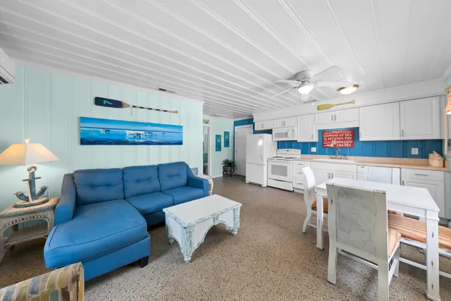 a dining room with furniture a window and a kitchen view