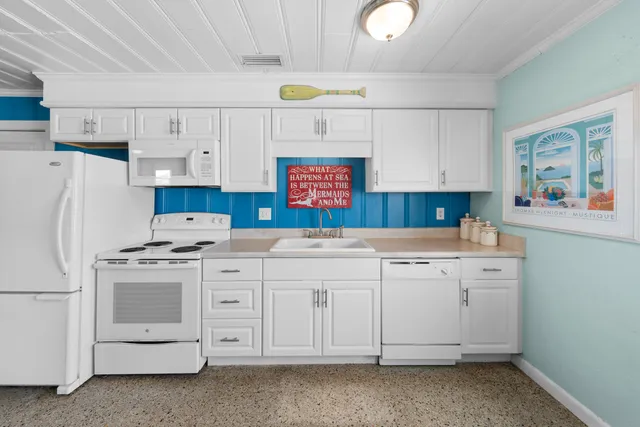 a spacious bedroom with a large bed and a lamp