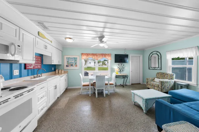 a bedroom with a bed and a flat tv screen on dresser