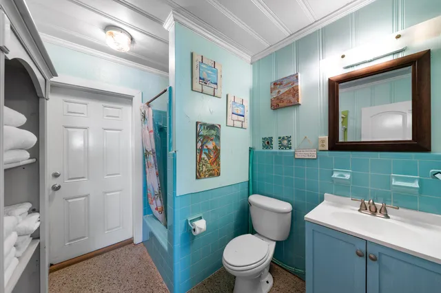 a dining room with furniture and a floor to ceiling window