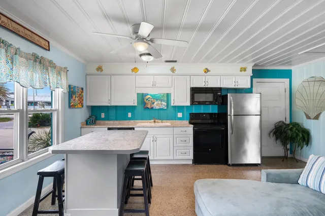 a spacious bedroom with a bed a lamp and a large mirror on the dresser