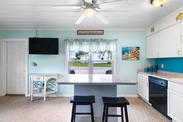 a bedroom with a bed and dresser with mirror