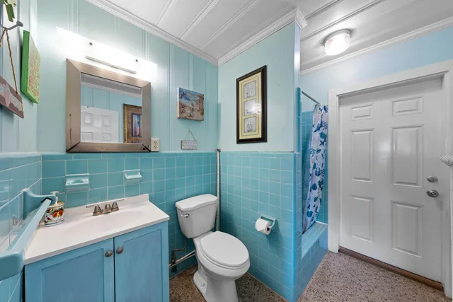 a living room with furniture and a dining table with garden view