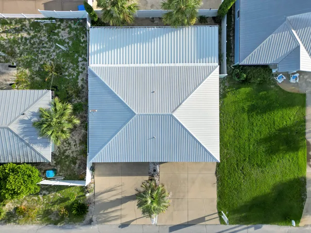 a backyard of a house with table and chairs