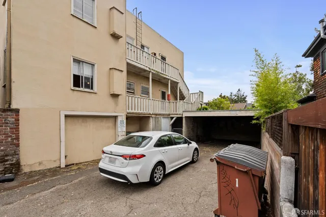 a car parked in front of a white building