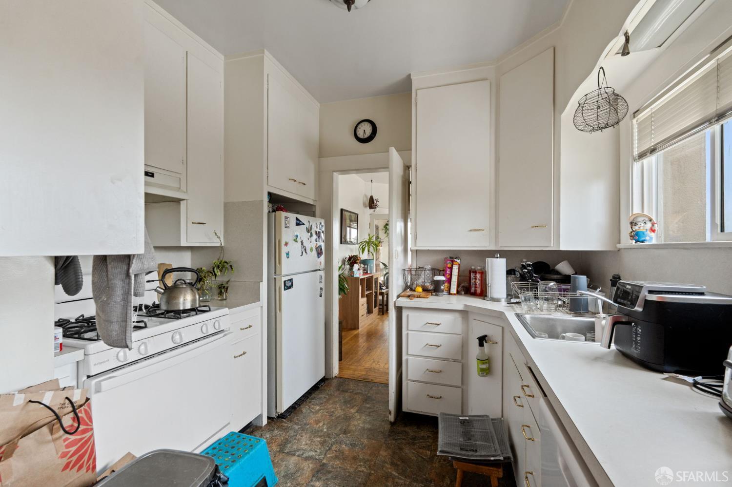 1849 Cedar Street Berkeley, CA 94703 - Photo 32 of 65 a kitchen with granite countertop a sink stove and refrigerator
