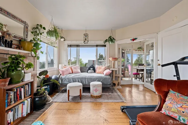 a bedroom with a bed a large window and chair