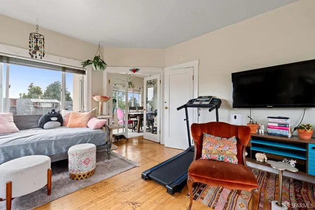 a bedroom with furniture and large windows