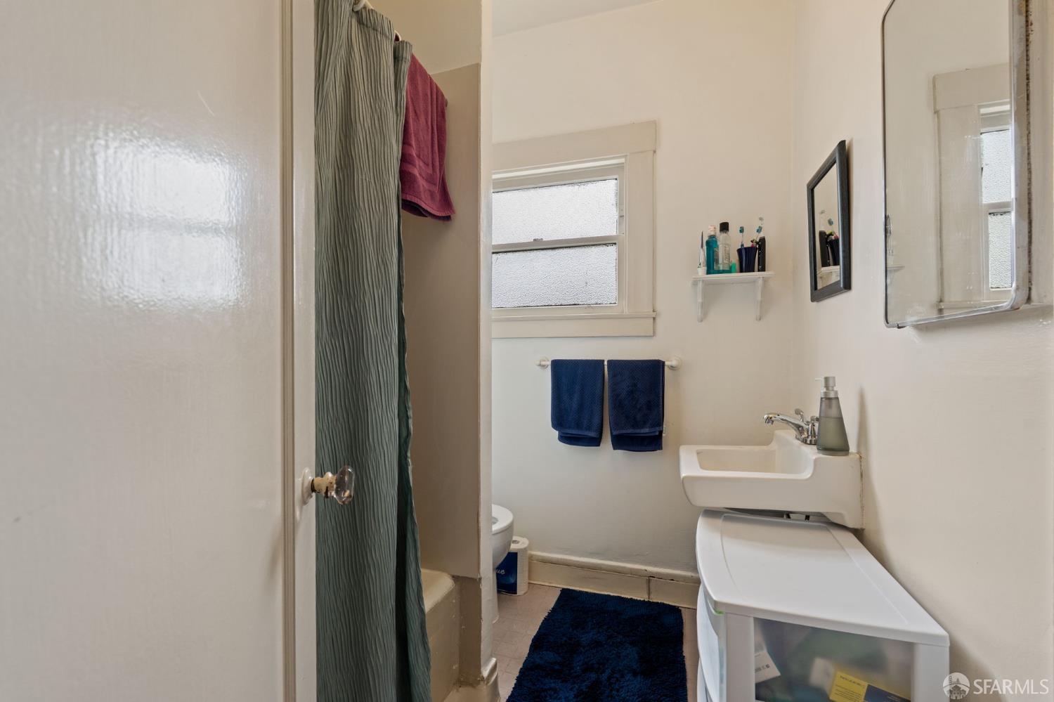 1849 Cedar Street Berkeley, CA 94703 - Photo 39 of 65 a bathroom with a sink and a mirror