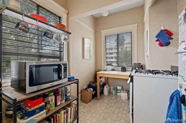a room with a sink cabinets and a window