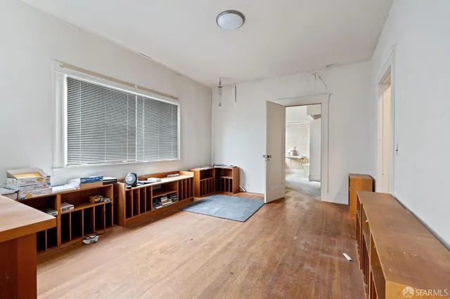 a room with stainless steel appliances kitchen island granite countertop a stove a sink and a wooden cabinets