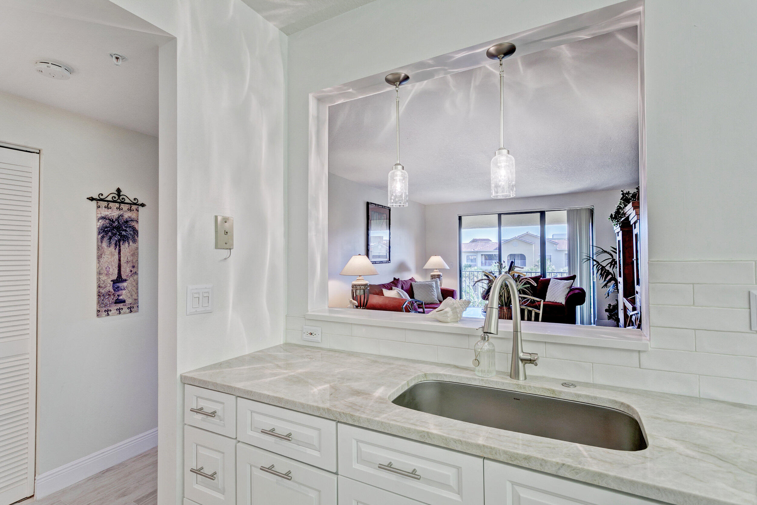 500 Uno Lago Drive, Unit 402 Juno Beach, FL 33408 - Photo 11 of 39 a bathroom with a sink and a mirror