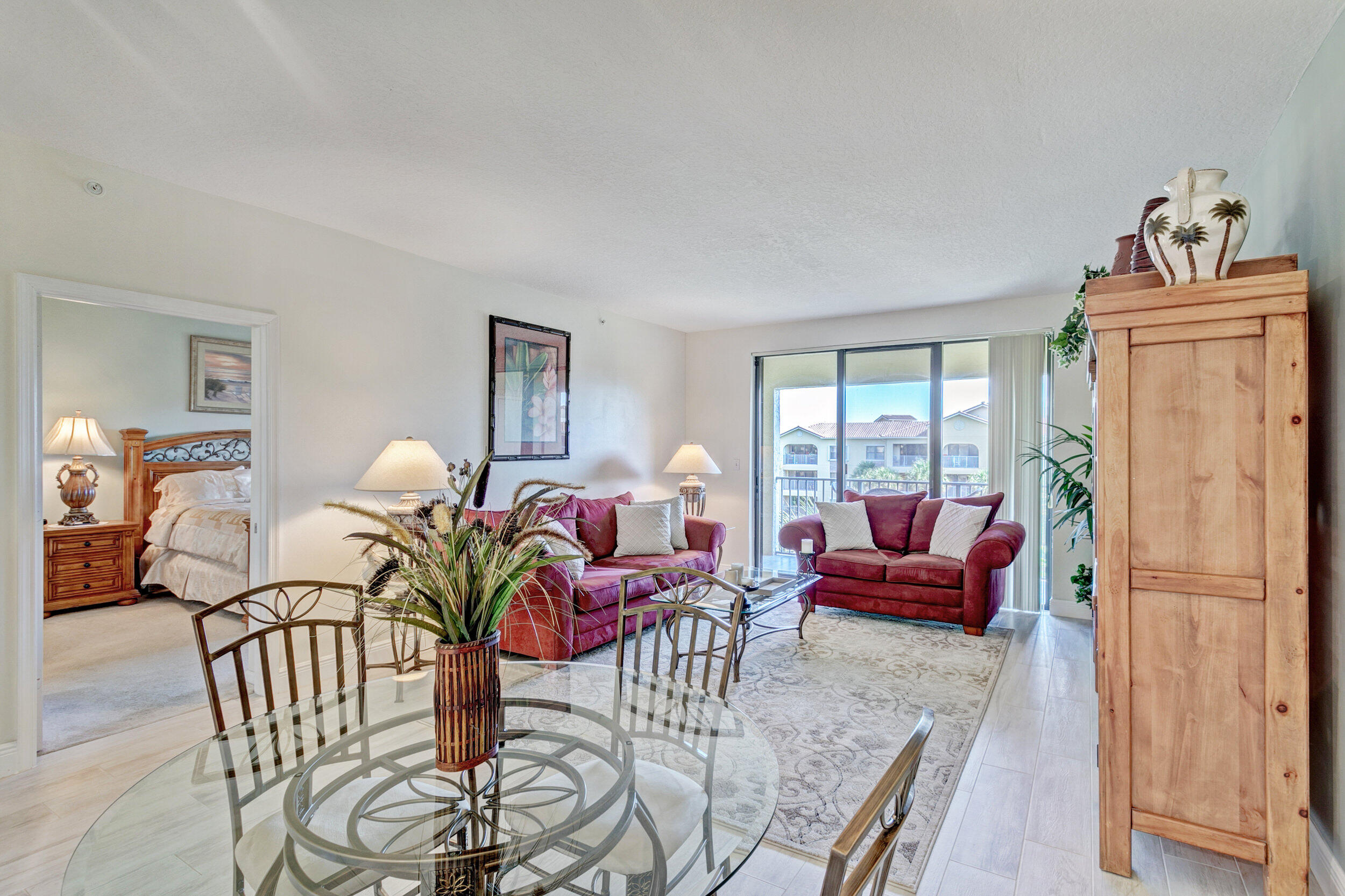 500 Uno Lago Drive, Unit 402 Juno Beach, FL 33408 - Photo 15 of 39 a living room with furniture or couch and a window