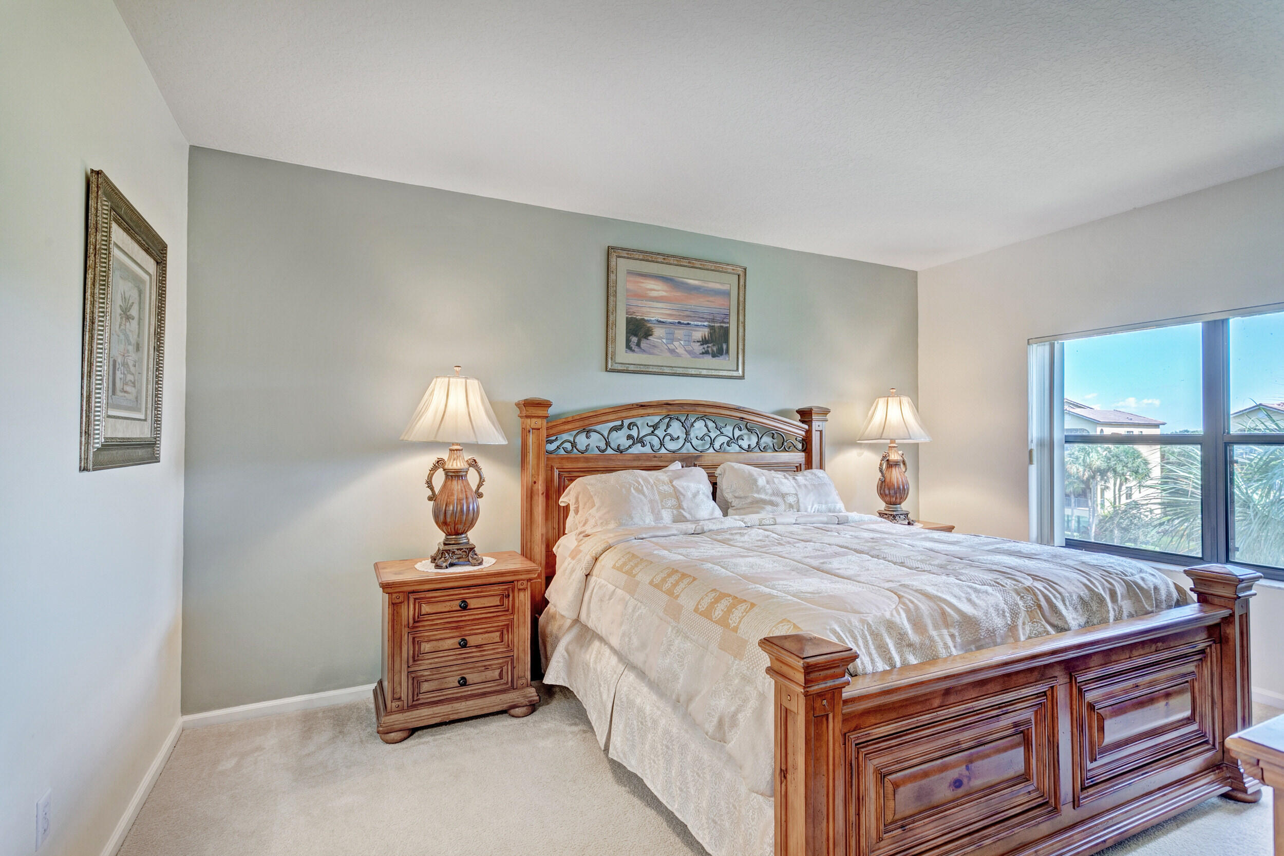 500 Uno Lago Drive, Unit 402 Juno Beach, FL 33408 - Photo 20 of 39 a bedroom with a bed and wooden floor