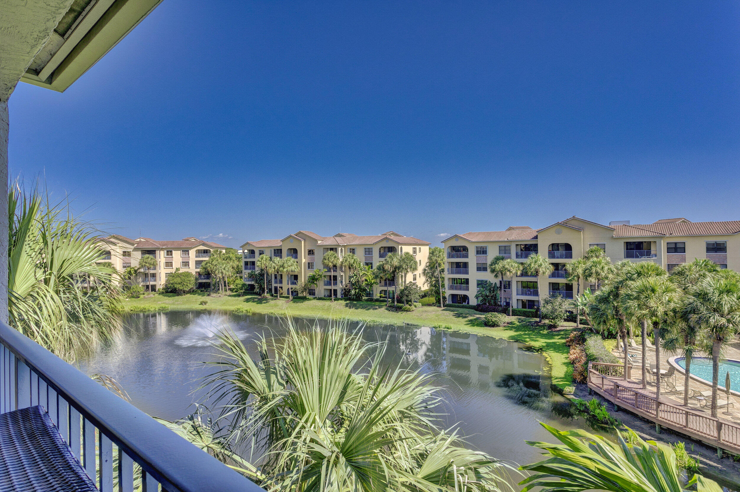 500 Uno Lago Drive, Unit 402 Juno Beach, FL 33408 - Photo 3 of 39 a view of a lake with a building in the background