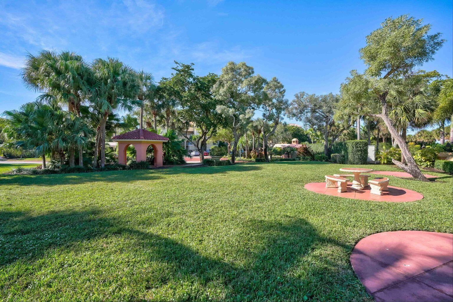 500 Uno Lago Drive, Unit 402 Juno Beach, FL 33408 - Photo 37 of 39 a front view of a house with garden