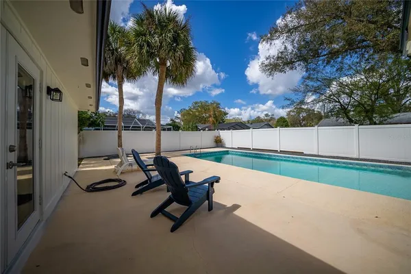 a view of house with swimming pool and porch