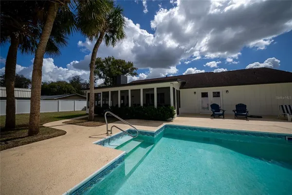 a view of a backyard with a garden and palm tree