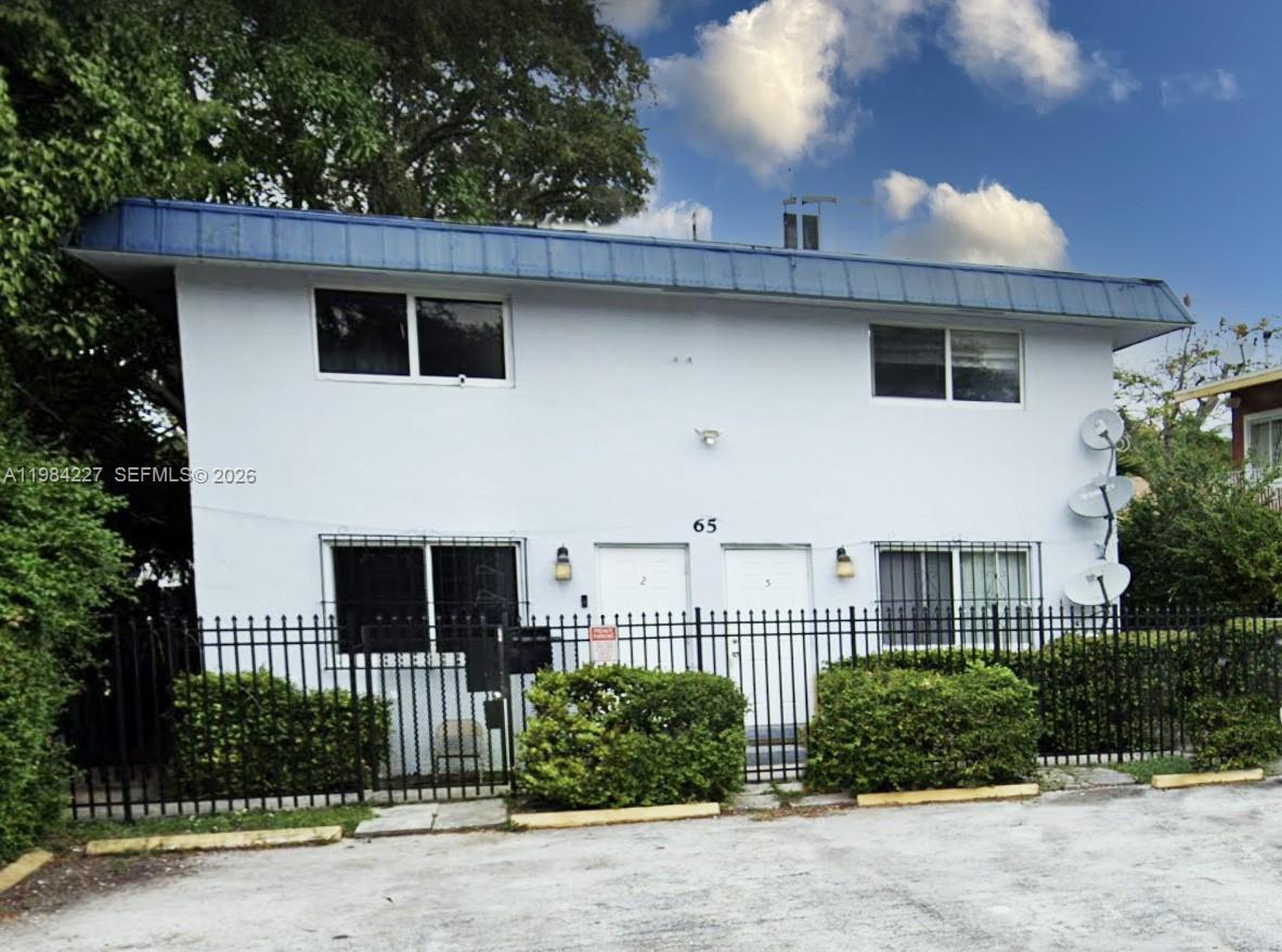 65 Northeast 59th Street, Unit 2 Miami, FL 33137 - Photo 12 of 14 a front view of a house with a garden